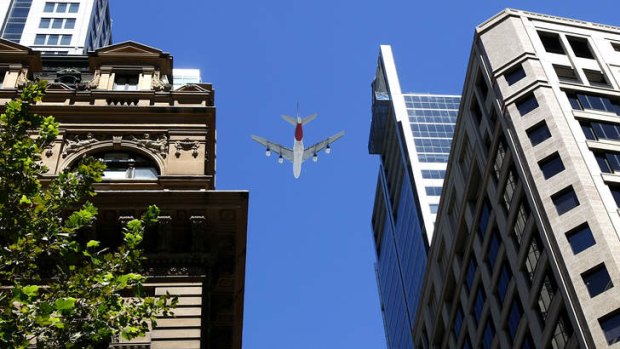 Qantas salute: An A380 superjumbo flies over Sydney's CBD in a tribute to James Strong.