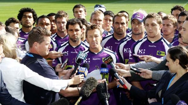 'We ain't going to surrender' ... Storm coach Craig Bellamy, backed by all his players, faces the media yesterday but all is not well behind the scenes.