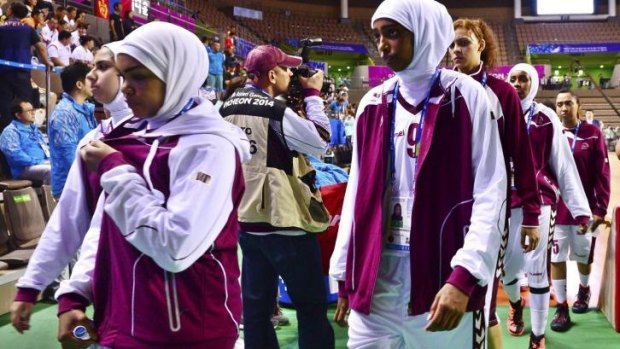 Qatar's women's basketball team leaves the court after forfeiting their women's basketball game against Mongolia.