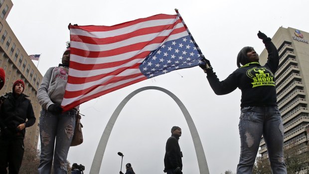 Protesters stand in front of the Gateway Arch - a famous tourist destination and monument known as 'the gateway to the west' - as they demonstrate in downtown St Louis.