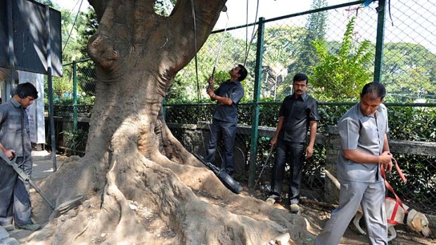 Indian bomb squad officials carry out a routine check outside the M. Chinnaswamy Cricket Stadium in Bangalore on Monday. Pakistan and India are due to play a T20 game at the stadium on Christmas Day.
