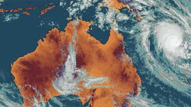 A satellite image shows Cyclone Tomas brewing off the north-east Australian coast.