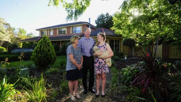 On the market: David and Helen Maybin with their daughter Tara, 15 are selling their family home in Fadden.