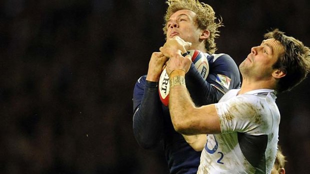 France centre Aurelien Rougerie competes for the ball with England fullback Ben Foden.