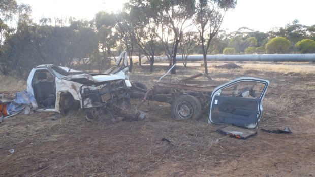 The crash tore the ute into two pieces, trapping the driver in the can section.