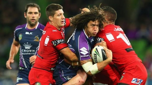 Kevin Proctor of the Strom is tackled by Gareth Widdop and Bronson Harrison of the Dragons.