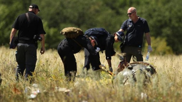 Australian Federal Police searching at the MH17 crash site for human remains.