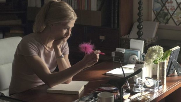 Word play: Amy (Rosamund Pike) considers one of her diary entries in the thriller <i>Gone Girl</i>.
