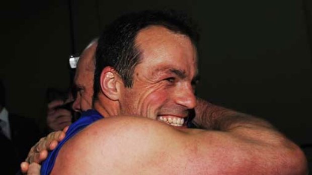 Another last hurrah: The Bulldogs' Brad Johnson hugs coach Rodney Eade after their narrow second semi-final win over Sydney.
