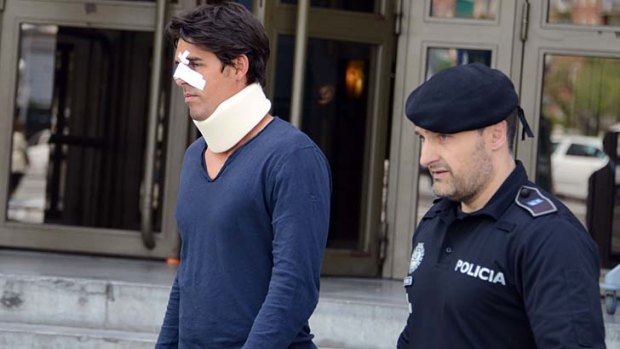 Bernard Tomic's training partner Thomas Drouet leaves court in Madrid looking battered after allegedly being headbutted by John Tomic.