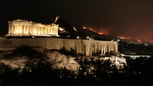 The fires in Athens, with the Acropolis on the left.