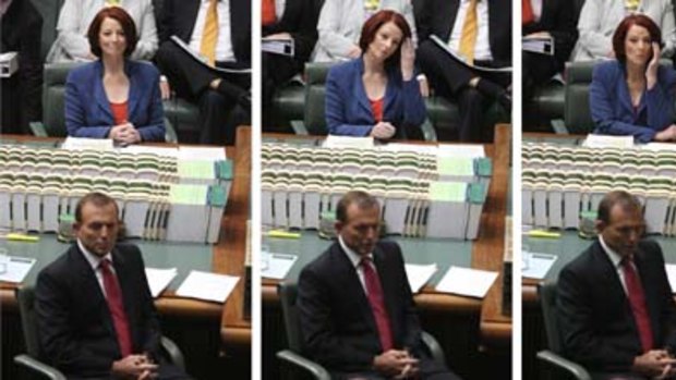 Better watch your back ... Julia Gillard and Tony Abbott during a tense question time yesterday.