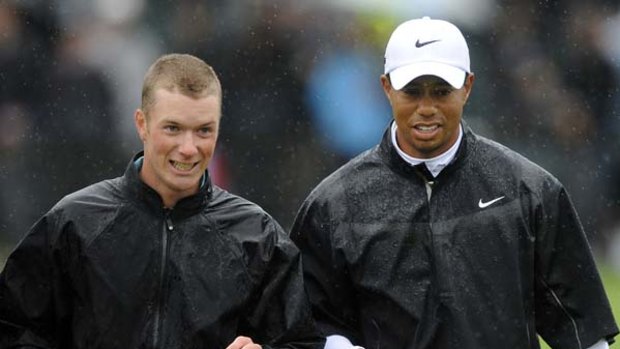 Kieran Pratt with Tiger Woods at the rain-soaked Australian Masters.