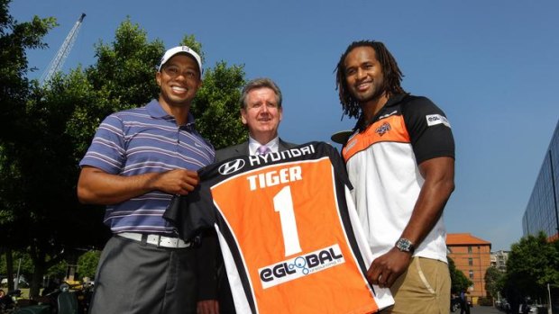 Tiger Woods is presented a Wests Tigers jumper from Lote Tuqiri and NSW Premier Barry O'Farrell this morning.