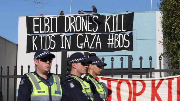 Protesters have climbed onto the roof of Elbit Systems in Port Melbourne.