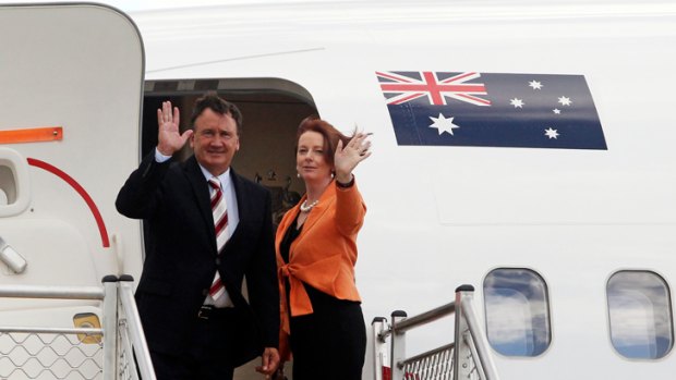 Julia Gillard and partner Tim Mathieson leave Melbourne for Singapore yesterday.