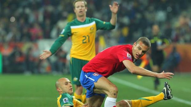 Undecided ... Mark Bresciano, pictured here falling in a tackle against Serbia.
