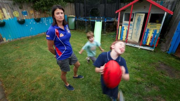 Five-time premiership coach and player Peta Searle at home with children Jackson and Tessa.