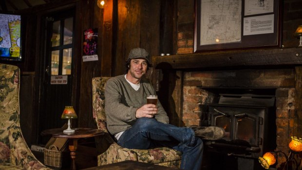 Old Canberra Inn co-owner Nick Diver relaxes with a drink.