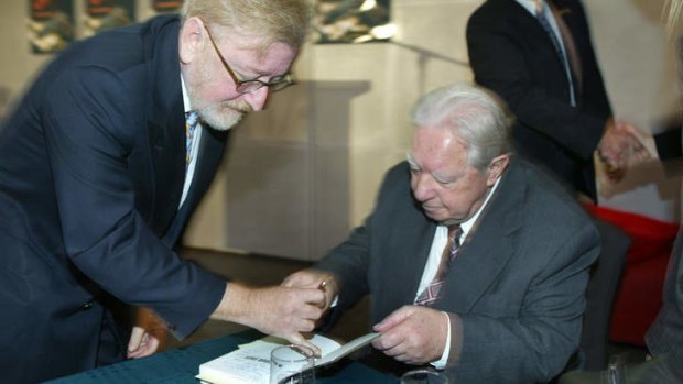 Billy Longley signs a copy of a book about his life for Robert Richter QC in 2005.