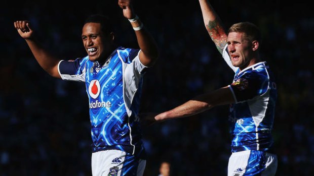 Glen Fisiiahi and Sam Tomkins of the Warriors celebrate a try during day one.