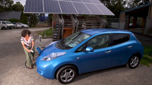 Judy Glick charging a car at the solar charge station at the CERES Community environment part in East Brunswick.