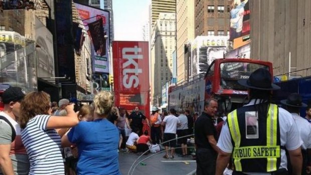 Pedestrians gather at the scene of the bus crash as first responders attend to 15 victims.