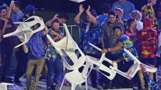 Drama: spectators throw chairs at an event in Melbourne in January.