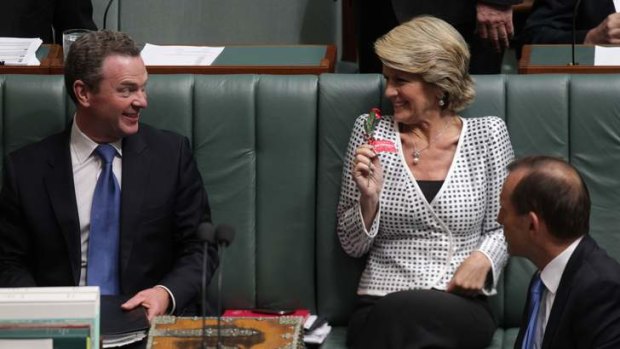 How sweet it is &#8230; the Deputy Opposition Leader, Julie Bishop, shows her chocolate rose to Christopher Pyne as Tony Abbott watches.