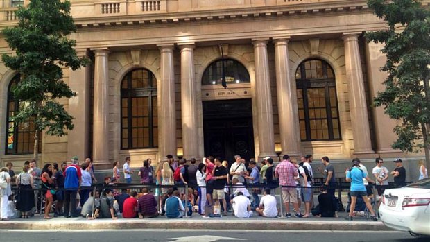 Shoppers line up outside Brisbane's new Apple store ahead of its opening.
