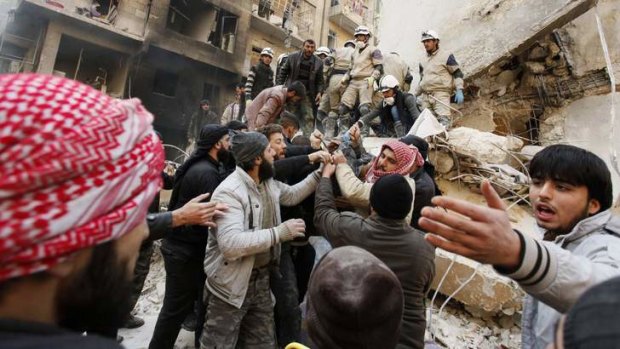 Free Syrian Army members remove a body from the rubble after an airstrike in Aleppo on December 17.