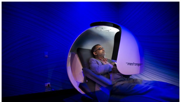 Mahil Mohamed takes time out for a 20 minute nap in a "sleep pod" at the Virgin Active Gym on Collins Street,  Melbourne.