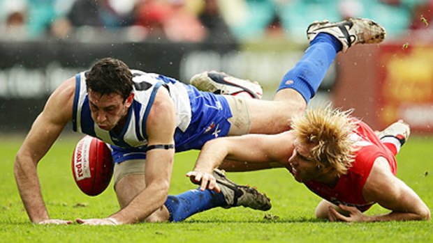 Desperation ..... North Melbourne's Todd Goldstein and Sydney's Lewis Roberts-Thomson compete for the ball.