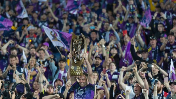 Simply the best: Cameron Smith hoists the premiership trophy.