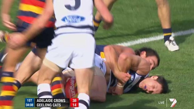 Adelaide's Taylor Walker tackles Geelong's Harry Taylor during the first quarter.