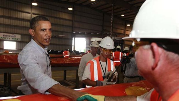 President Barack Obama visits   workers repairing oil containment booms  in Theodore, Alabama.