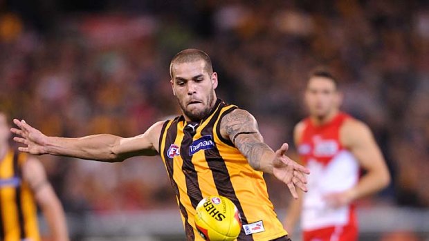 Man of the moment: Lance Franklin kicks one of his four goals.