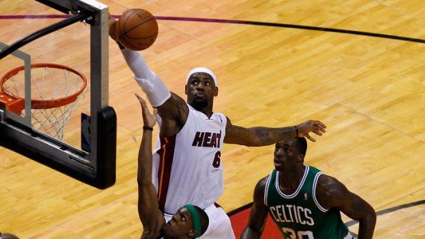 LeBron James of the Miami Heat blocks the shot of Rajon Rondo of the Boston Celtics.