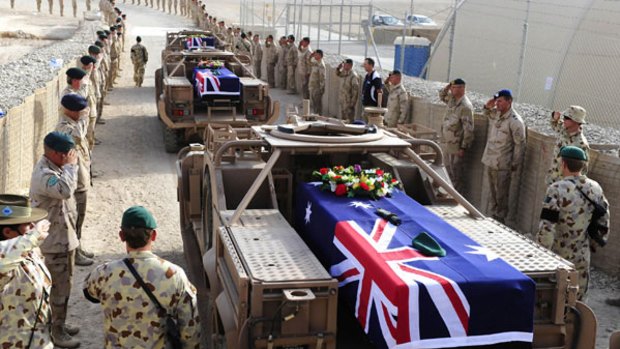 Special Operations Task Group Members and guests attending a memorial service in Tarin Kowt for Pte Benjamin Adam Chuck, Pte Timothy James Aplin and Pte Scott Travis Palmer, prior to them being flown home for burial. <i>Photo: AFP</i>