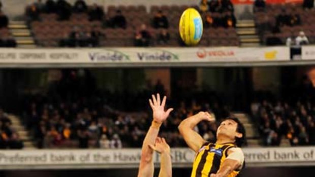 Cyril Rioli shows his amazing athleticism, leaping high above Western Bulldogs' ruckman Will Minson on Friday.