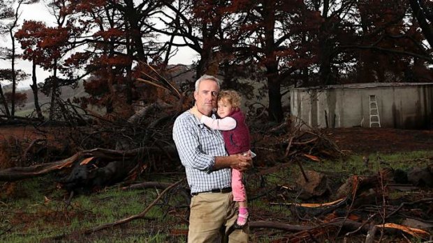 Matthew Cleve and daughter Maggie on their burnt property. Photo: Pat Scala
