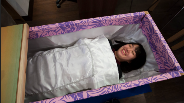 "It was very relaxing", said Miwa Okomoto's father before she tried out the coffin herself.