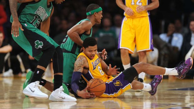 Los Angeles Lakers recruit Kent Bazemore struggles for the ball with Boston Celtics guard Rajon Rondo at Staples Center.