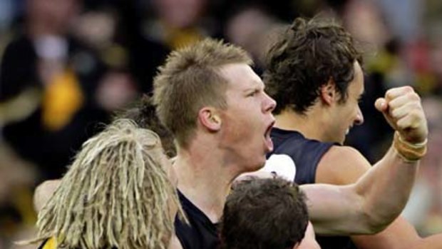 Jack Riewoldt celebrates with his teammates after kicking his 10th goal.