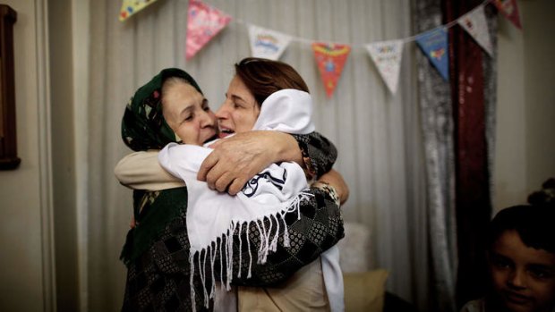Nasrin Sotoudeh and her mother-in-law embrace in Tehran. Ms Sotoudeh had just been released after a three-year internment.