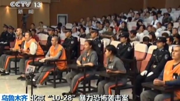 Six of the eight prisoners (seated - in orange and brown) in court in the Xinjiang capital Urumqi for the trial for October's Tiananmen Square attack that killed two tourists. 