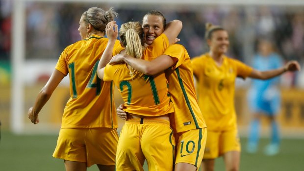 Emily Van Egmond celebrates with Ellie Carpenter.