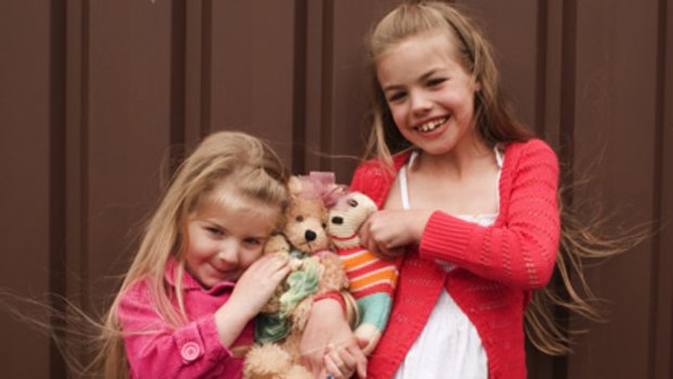 Cuddle fest  ... Kirstyn, left,  and Taylor Laws, who have cystic fibrosis,   will attend their first Teddy Bears’ Picnic.