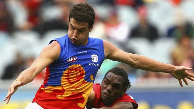 Another defeat ... Tom Rockliff kicks under pressure during the Lions' defeat to the Demons.