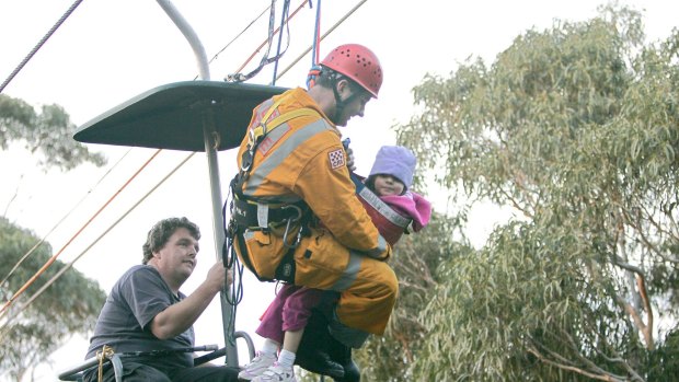 Rescue: A CFA fireman assists four-year-old Sarah Lark in 2006 at the Arthurs Seat chairlift on which she and her father Ian had been for the best part of four hours. 